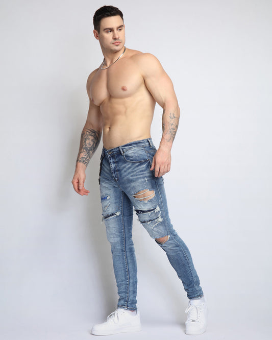 Logeqi Cashew Blossom patched jeans for men featuring distressed detailing and a stylish fit
