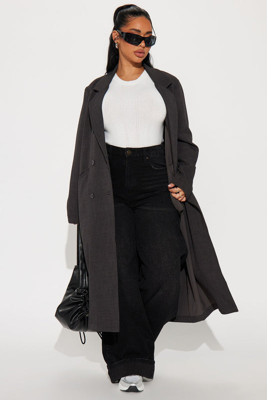 Stylish charcoal trench coat for women paired with a white top and black wide-leg jeans