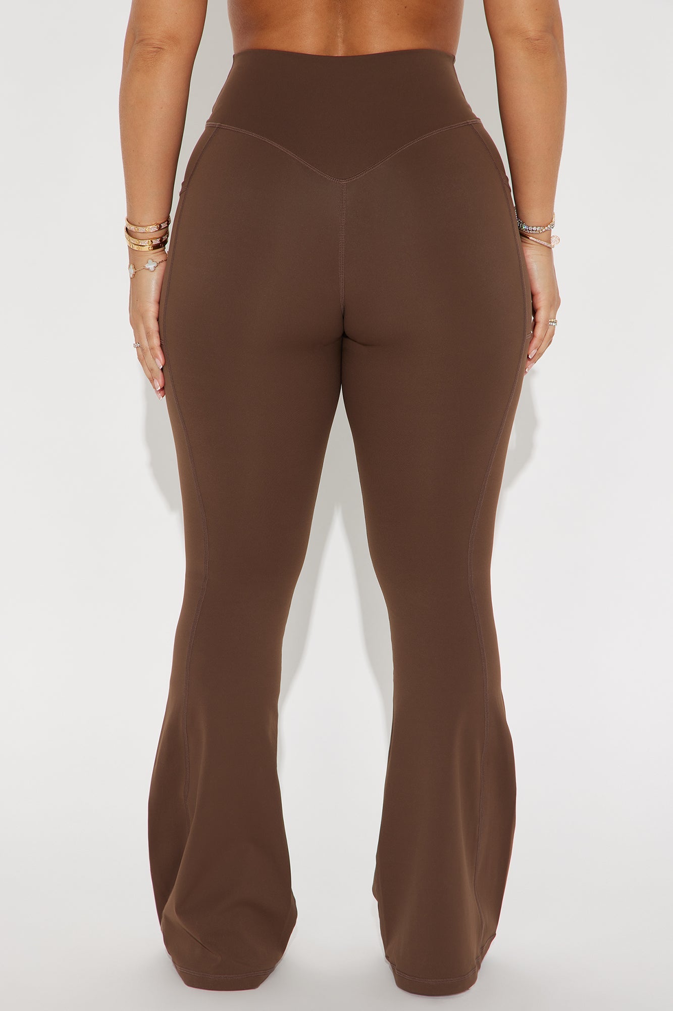 Chocolate brown active leggings with a high waist and flared design for a stylish workout look