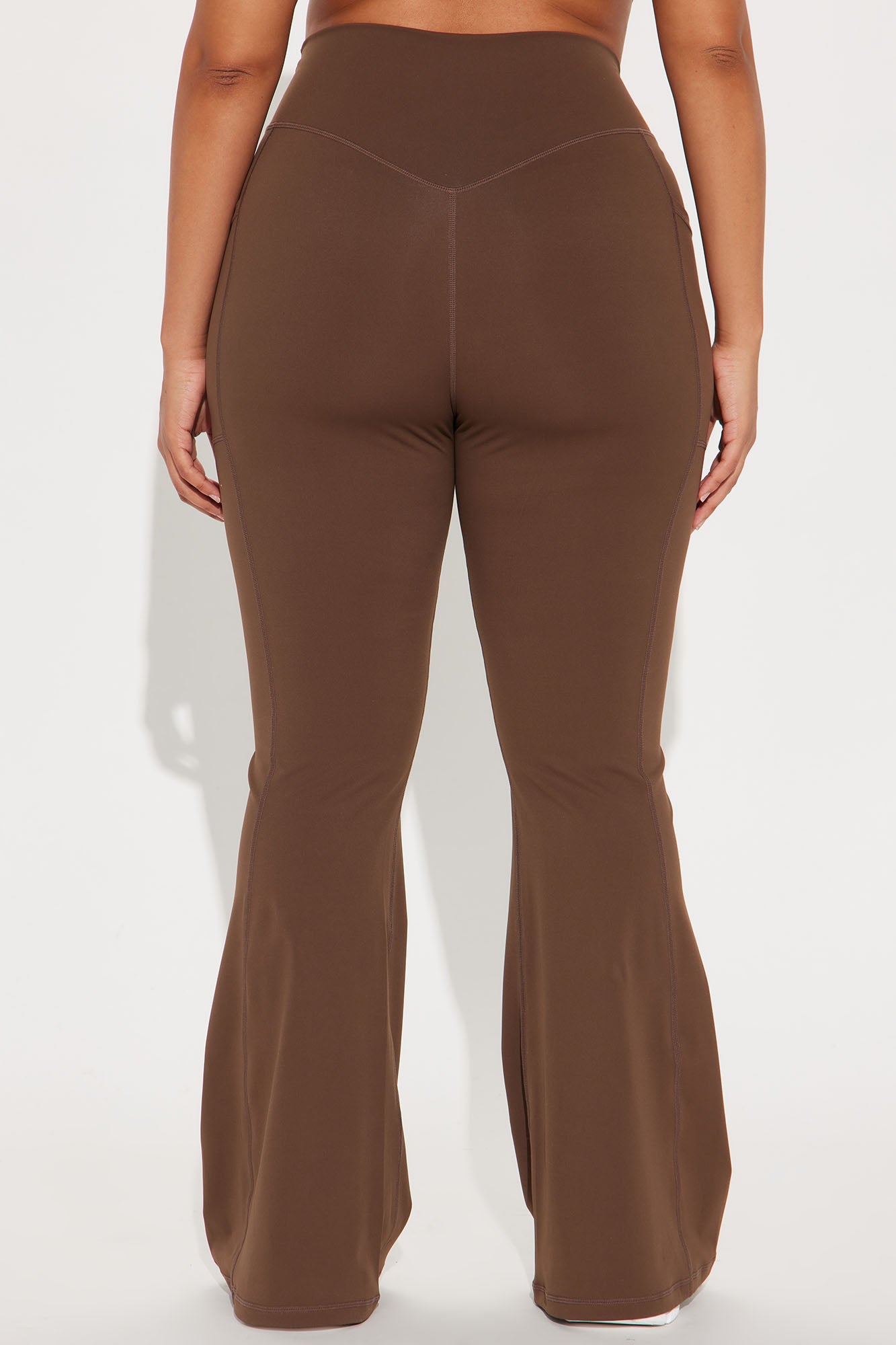 Chocolate brown active leggings by Fashion Nova featuring a flattering flared design on the back