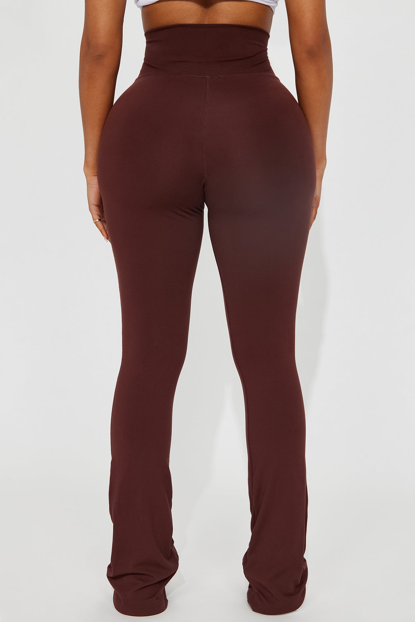 Back view of chocolate yoga pants for women with high waistband and stretchable fabric