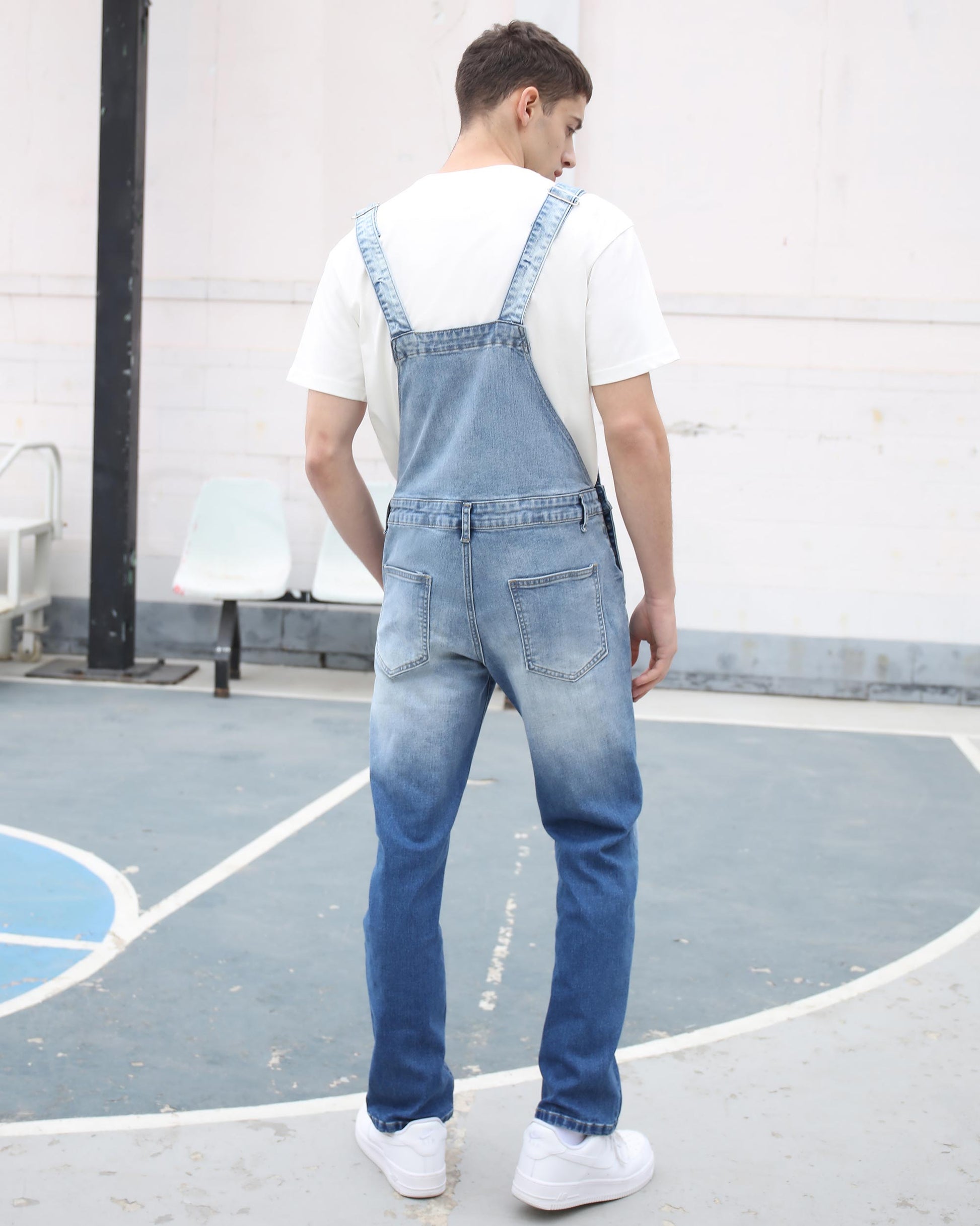 Logeqi classic denim overalls with adjustable straps worn by a man on a basketball court