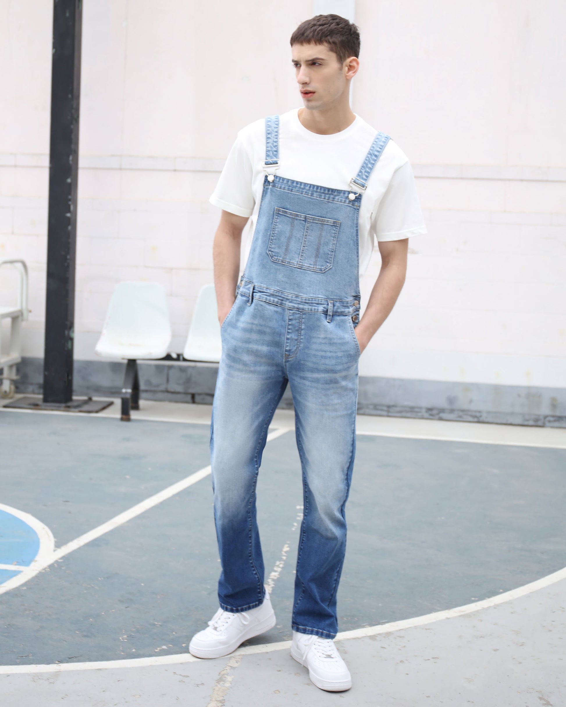 Logeqi classic denim overalls in light blue worn by a man with white sneakers and a white t-shirt