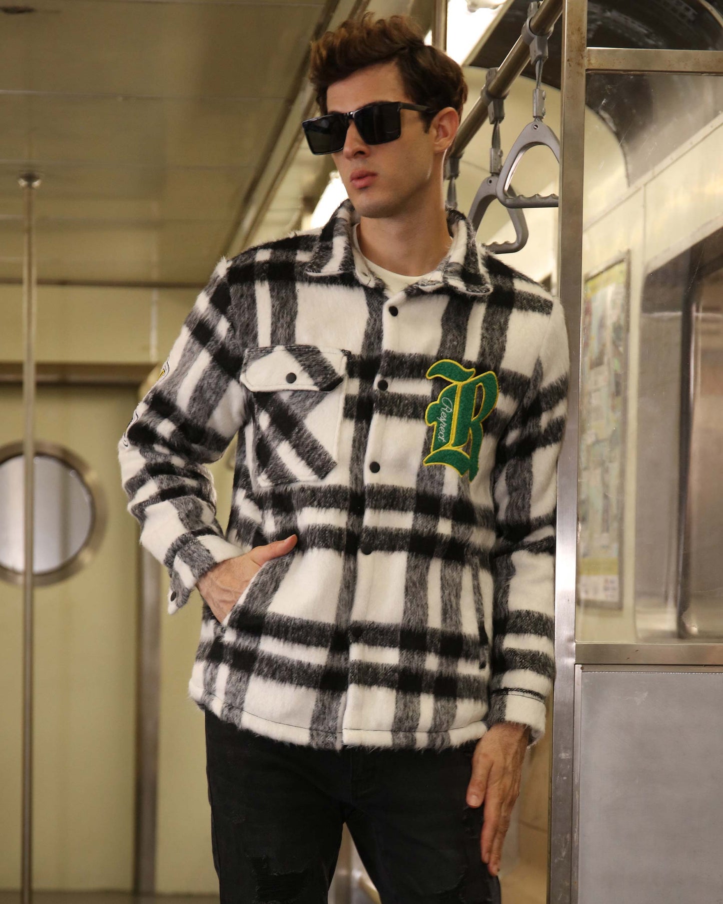 Logeqi classic plaid moto jacket in black and white worn by a man with sunglasses in a subway setting