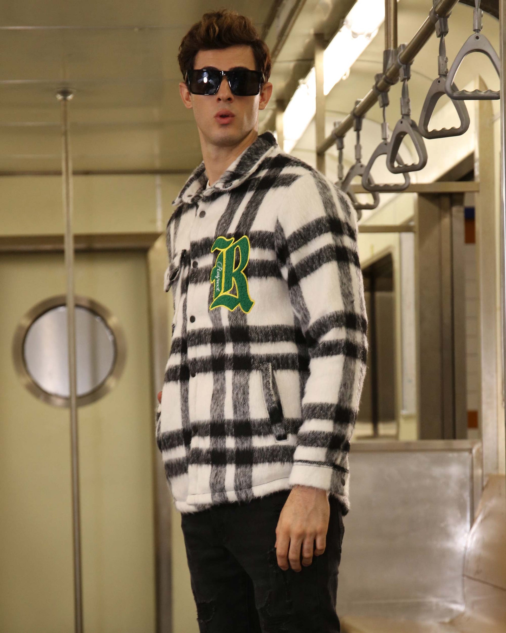 Logeqi classic plaid moto jacket in black and white with green letter patch worn by man with sunglasses