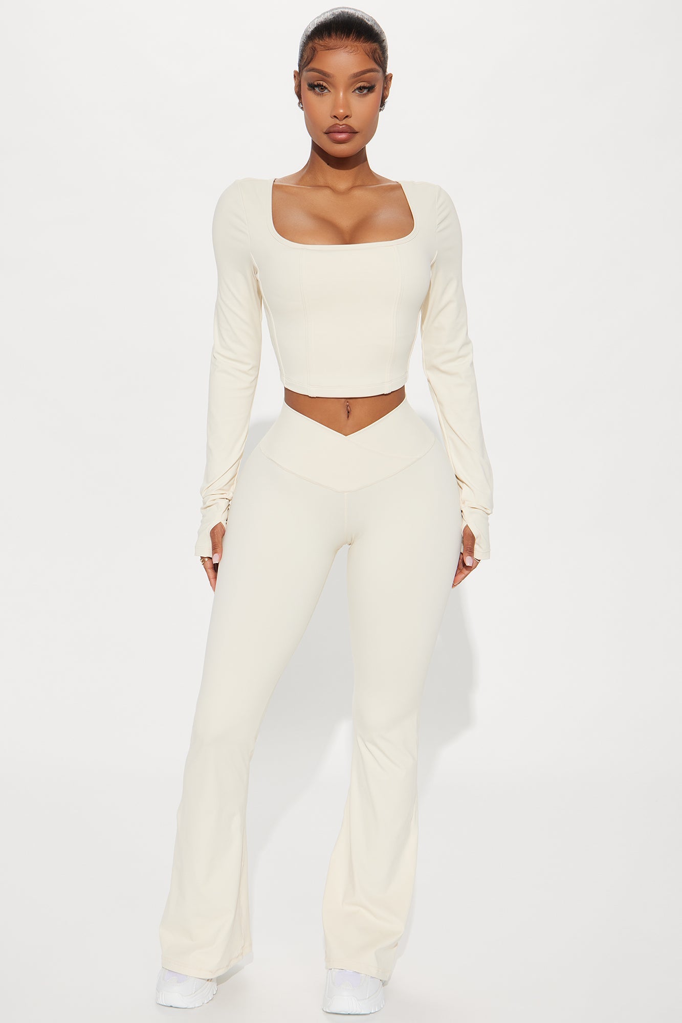 Model wearing cream active leggings for women with a matching long-sleeve crop top for a stylish workout look