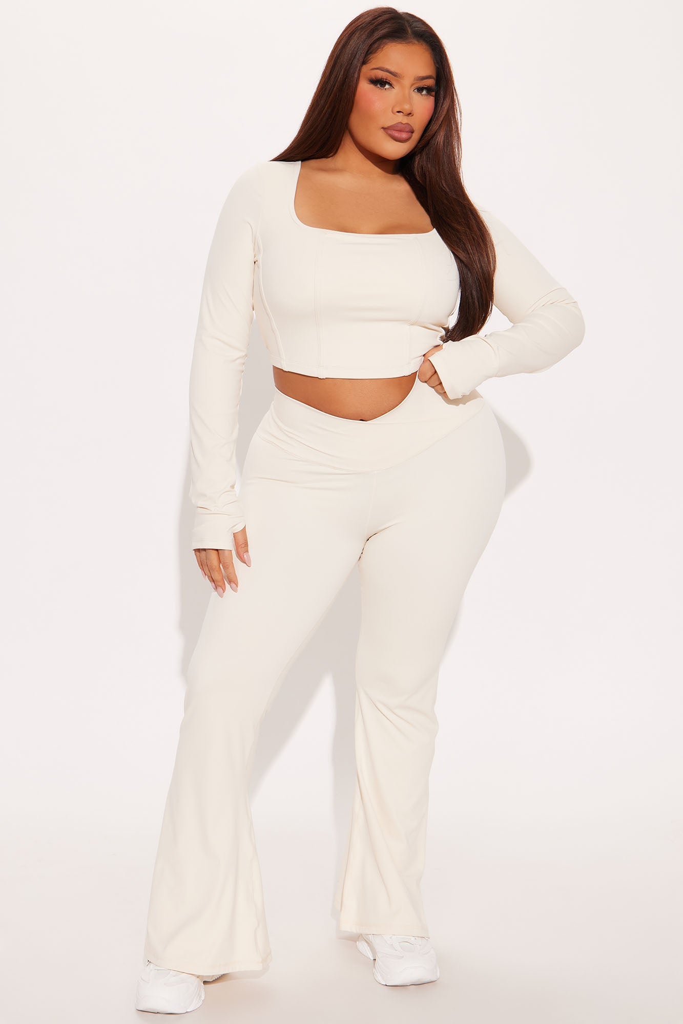 Cream active leggings for women paired with a matching long-sleeve crop top for a stylish look