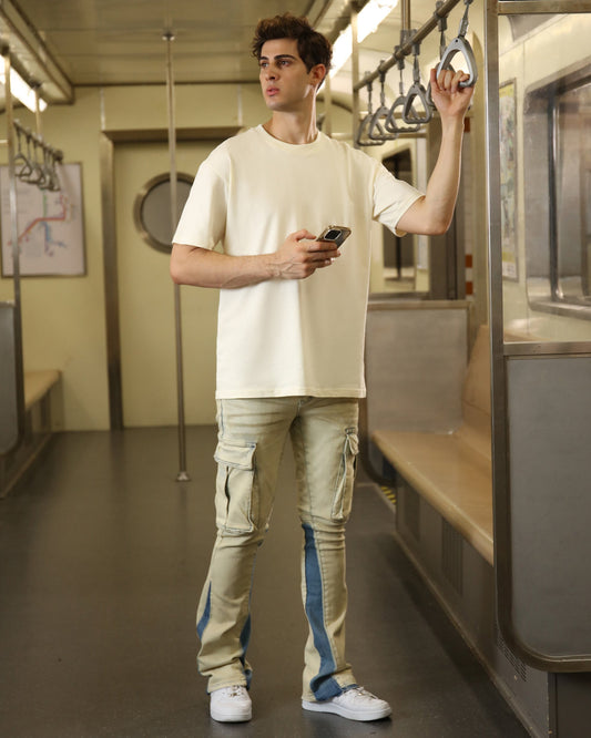 Logeqi cream oversized t-shirt on a model in a subway, styled with casual pants
