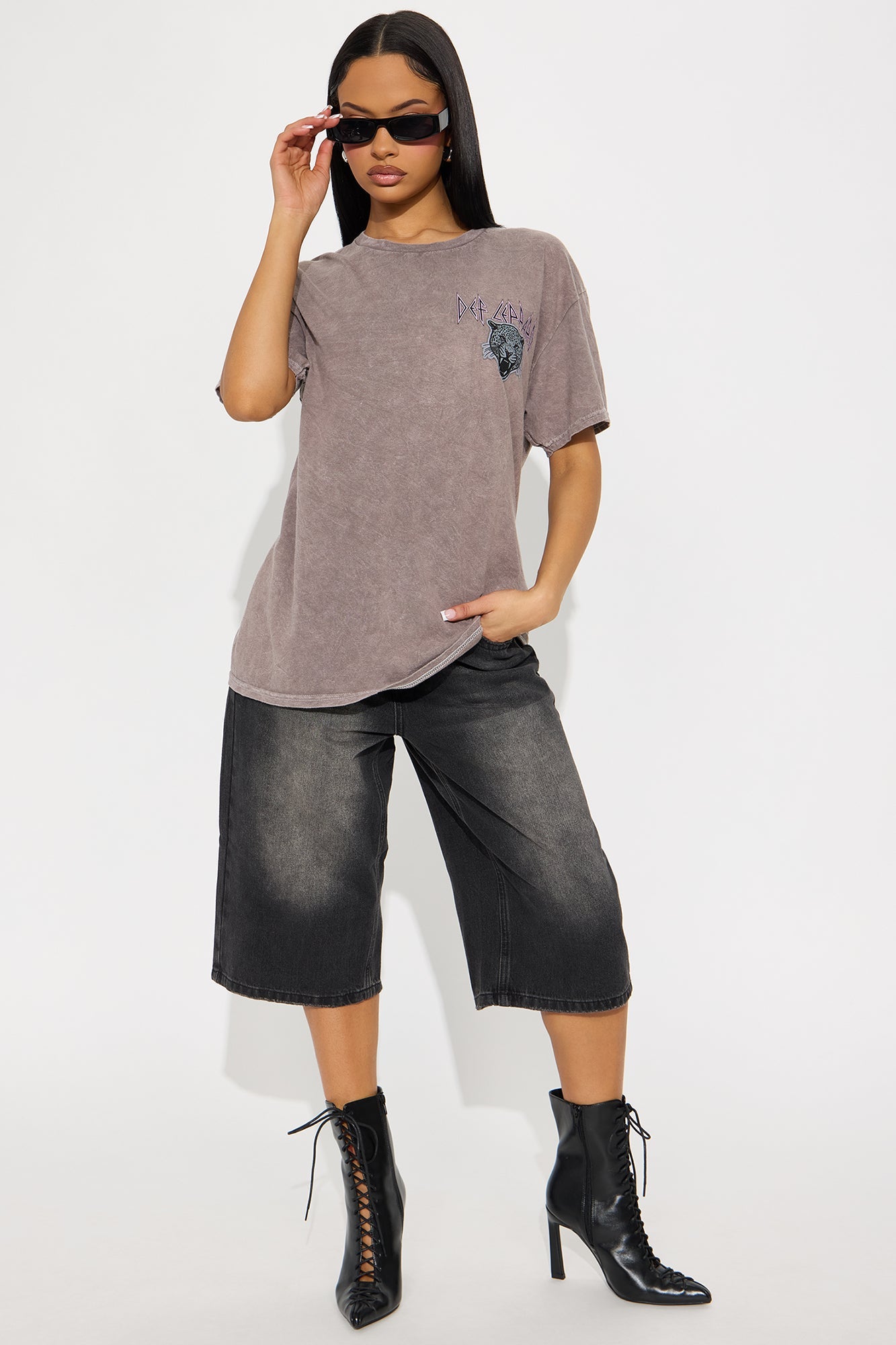 Def Leppard washed tee in brown with graphic print, paired with stylish black shorts and boots