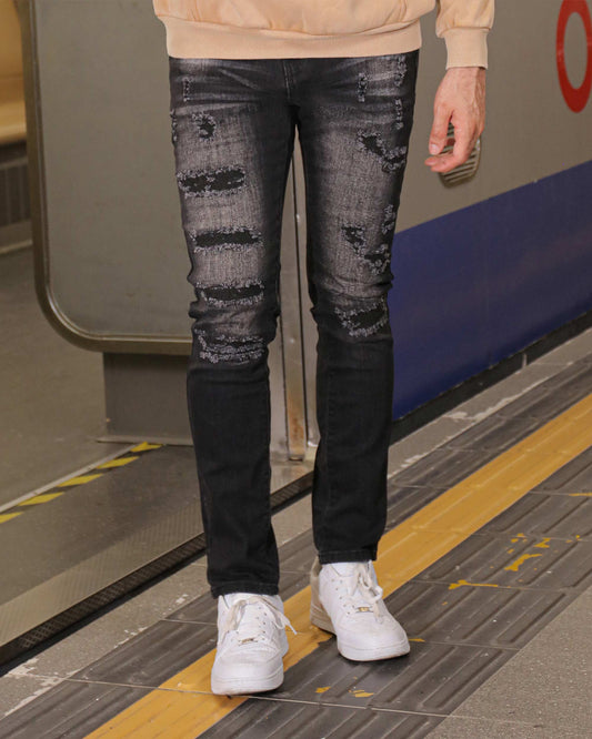Logeqi distressed black ripped jeans worn by a person standing on a subway platform