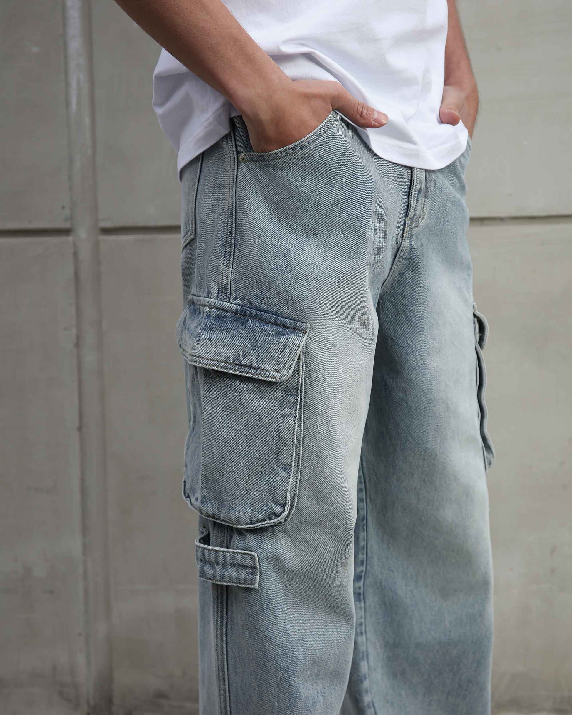 Logeqi distressed blue baggy jeans with cargo pockets worn with white t-shirt