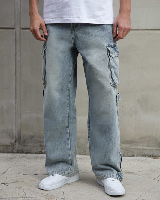 Logeqi distressed blue baggy jeans with cargo pockets worn with white sneakers and a white shirt