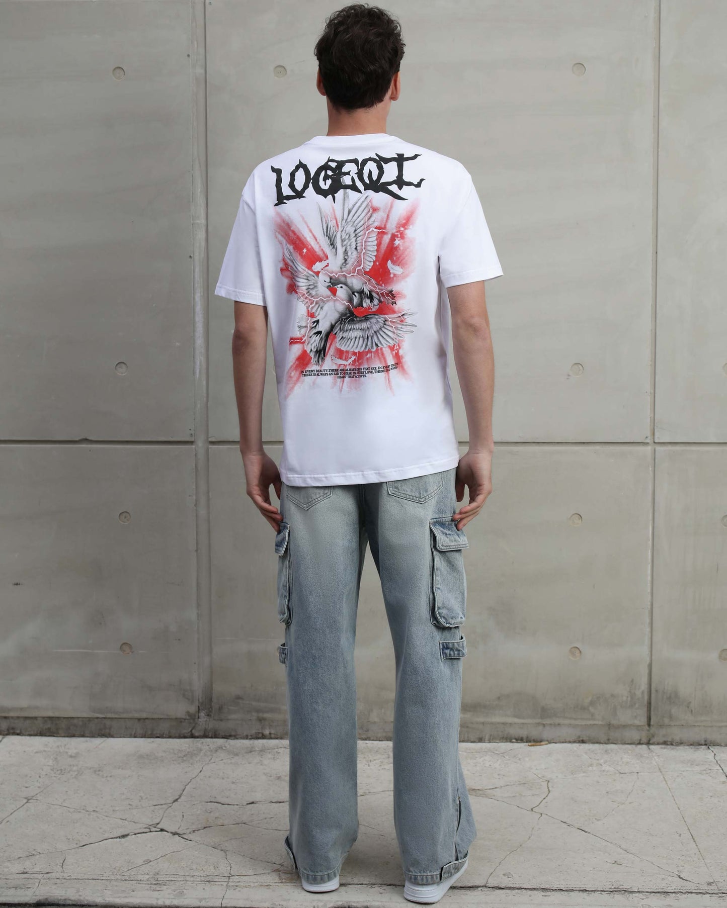 Man wearing Logeqi distressed blue baggy jeans with cargo pockets and relaxed fit from the back