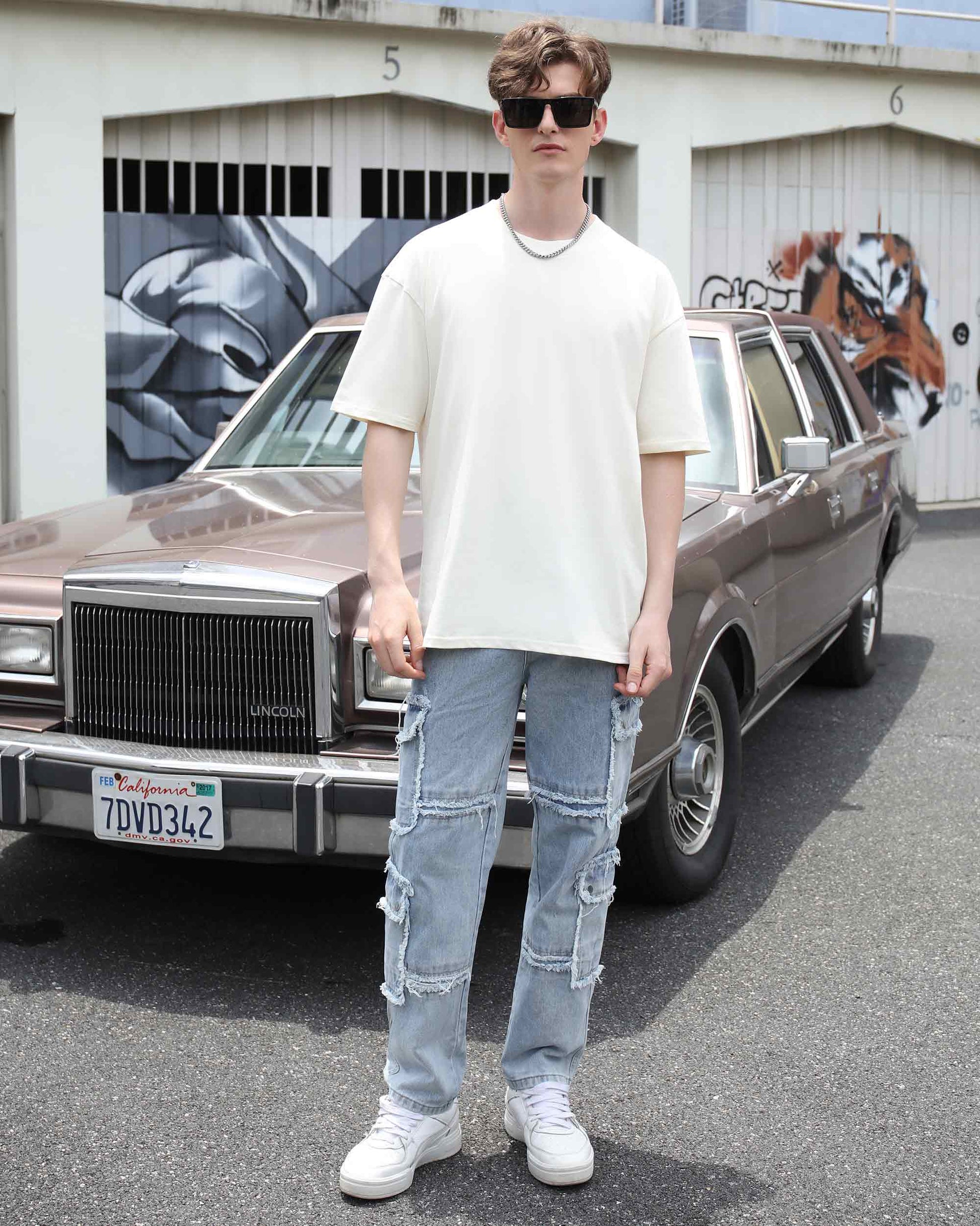 Logeqi essential solid t-shirt in cream color, styled casually with distressed jeans and sunglasses