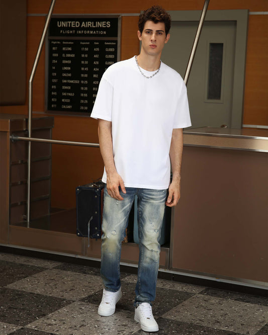Logeqi essential solid t-shirt in white, paired with distressed denim and white sneakers for a casual look