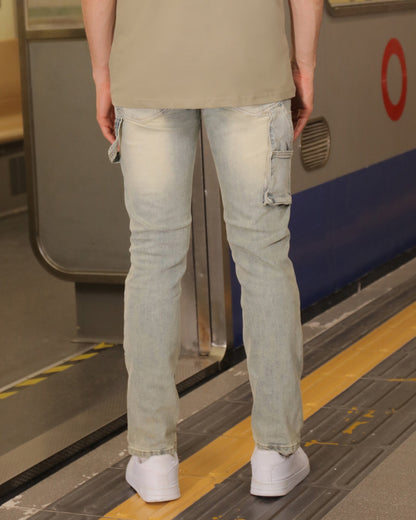 Back view of a man wearing Logeqi essential solid tee with light wash jeans in a subway setting