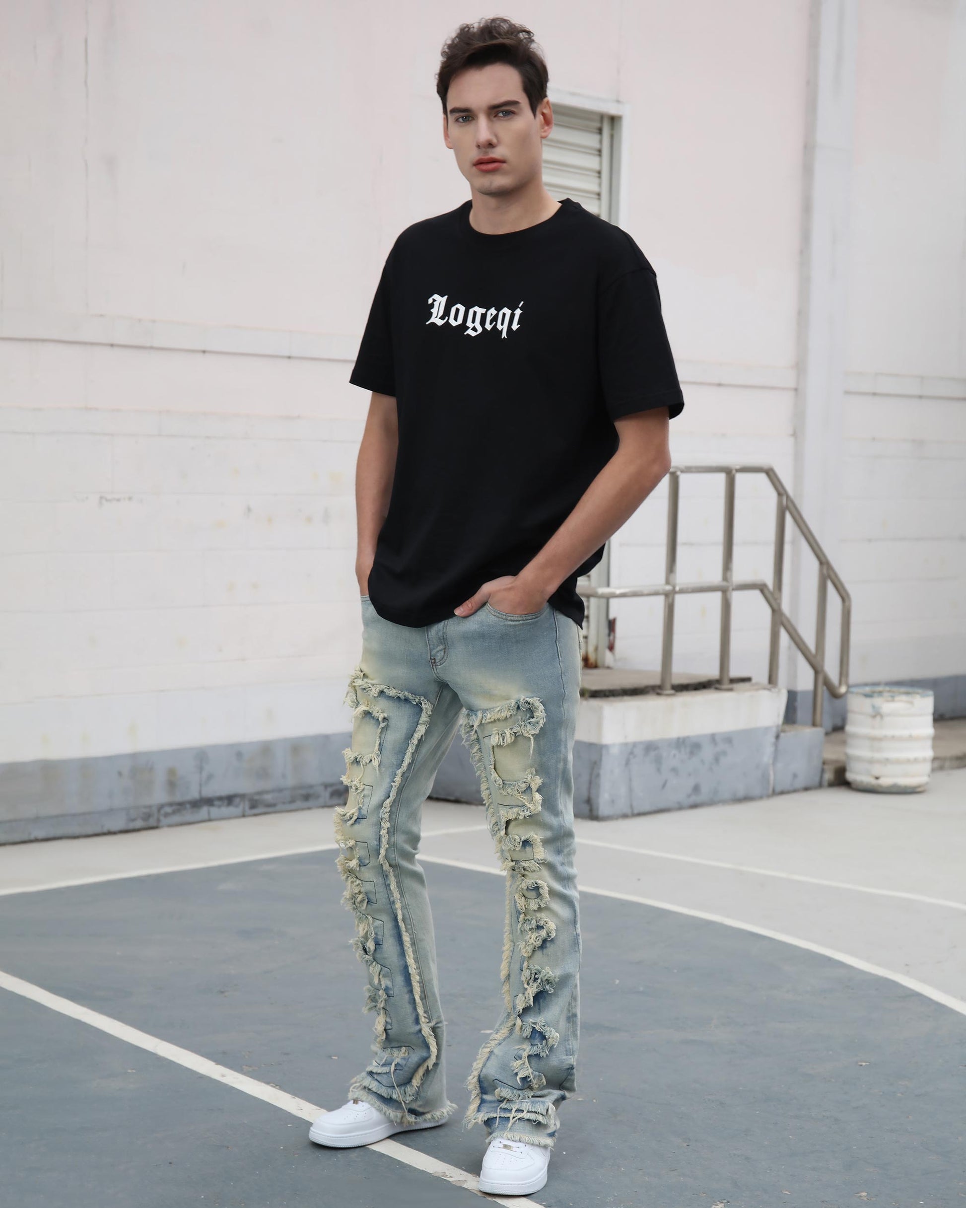 Logeqi fringe flared jeans with heavy ripped fringe details worn by male model with black t-shirt