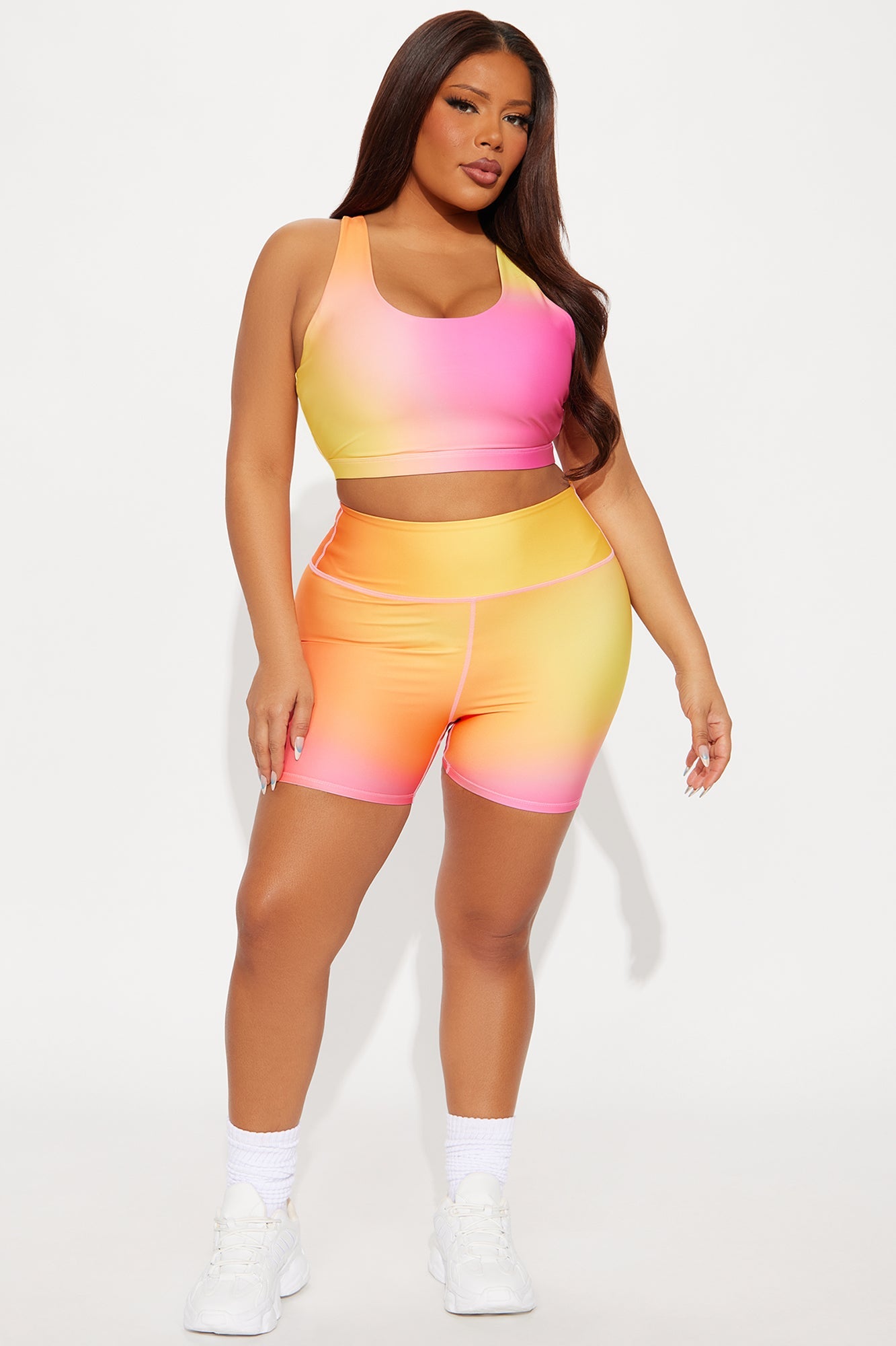 Fuchsia activewear set for women featuring a sporty crop top and matching shorts in a vibrant gradient design