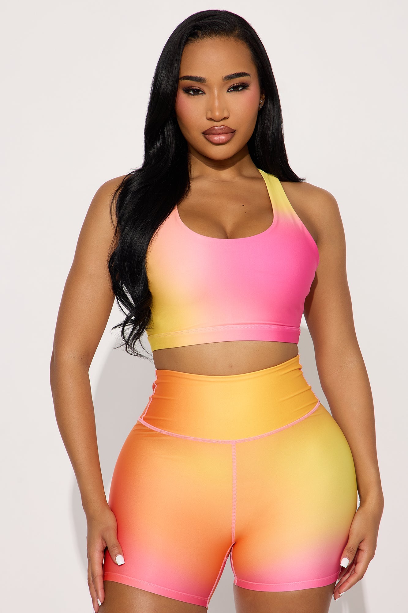 Fuchsia activewear set for women featuring a gradient sports bra and high-waisted shorts