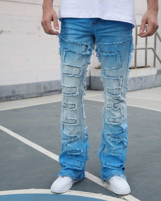 Logeqi gradient blue flare jeans with patchwork and distressed details worn with white sneakers