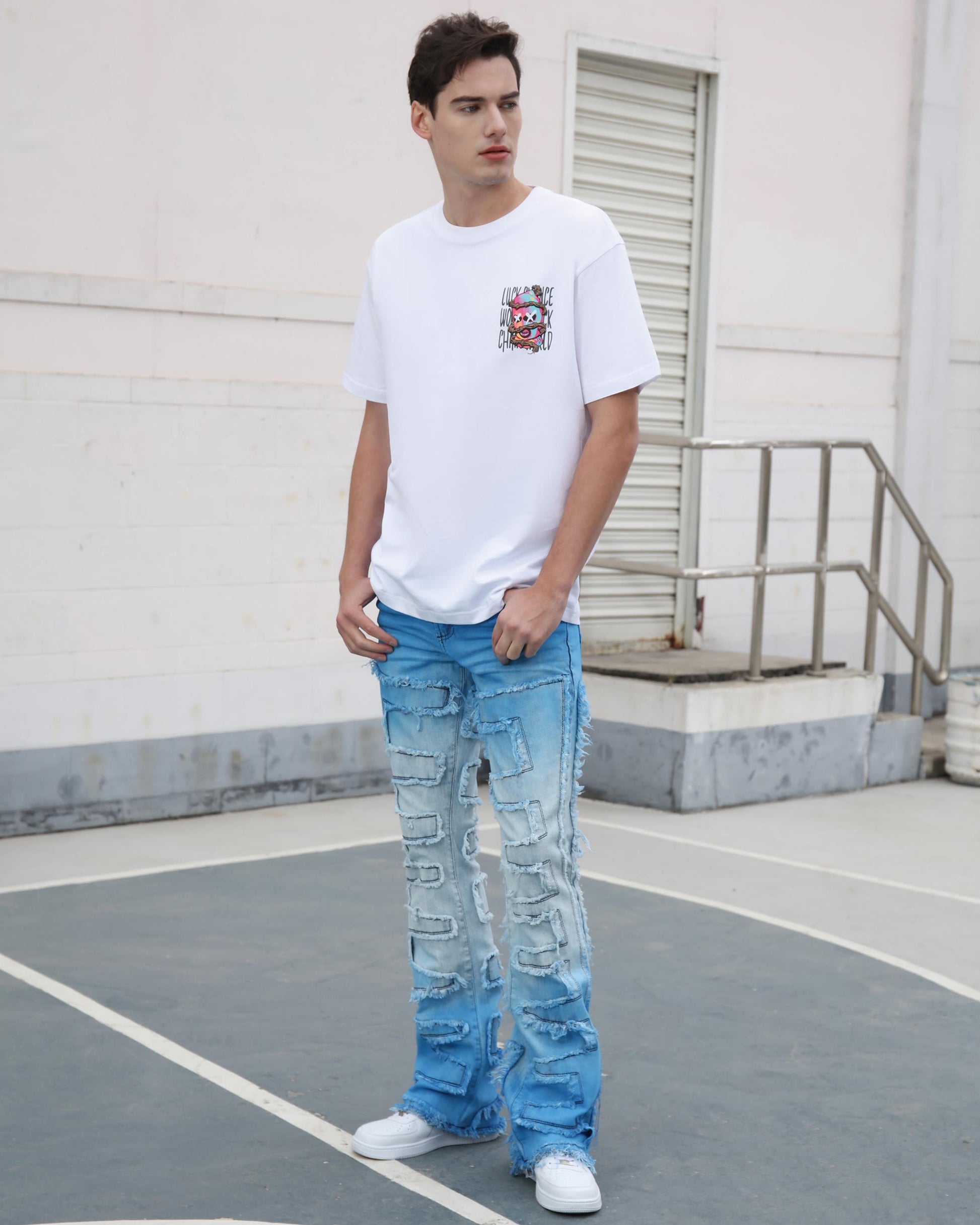 Man wearing Logeqi gradient blue flare jeans with distressed detailing and white casual t-shirt