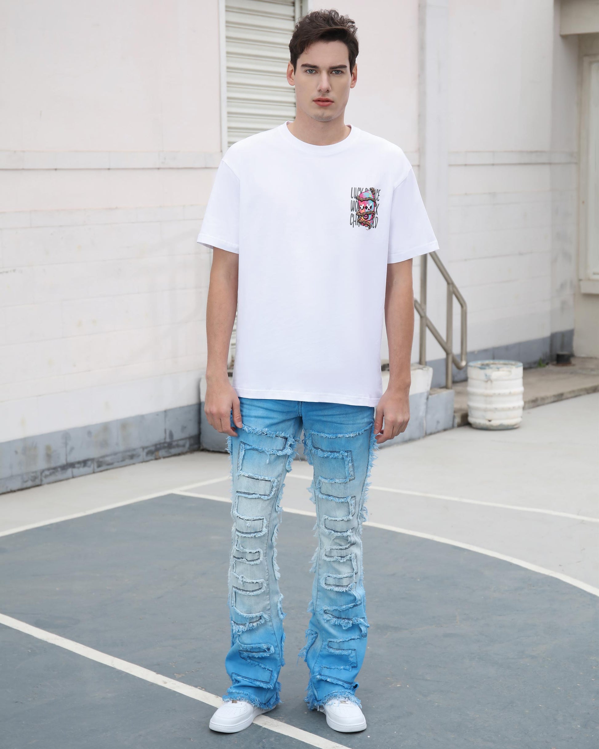 Logeqi gradient blue flare jeans with distressed details worn by male model in white sneakers