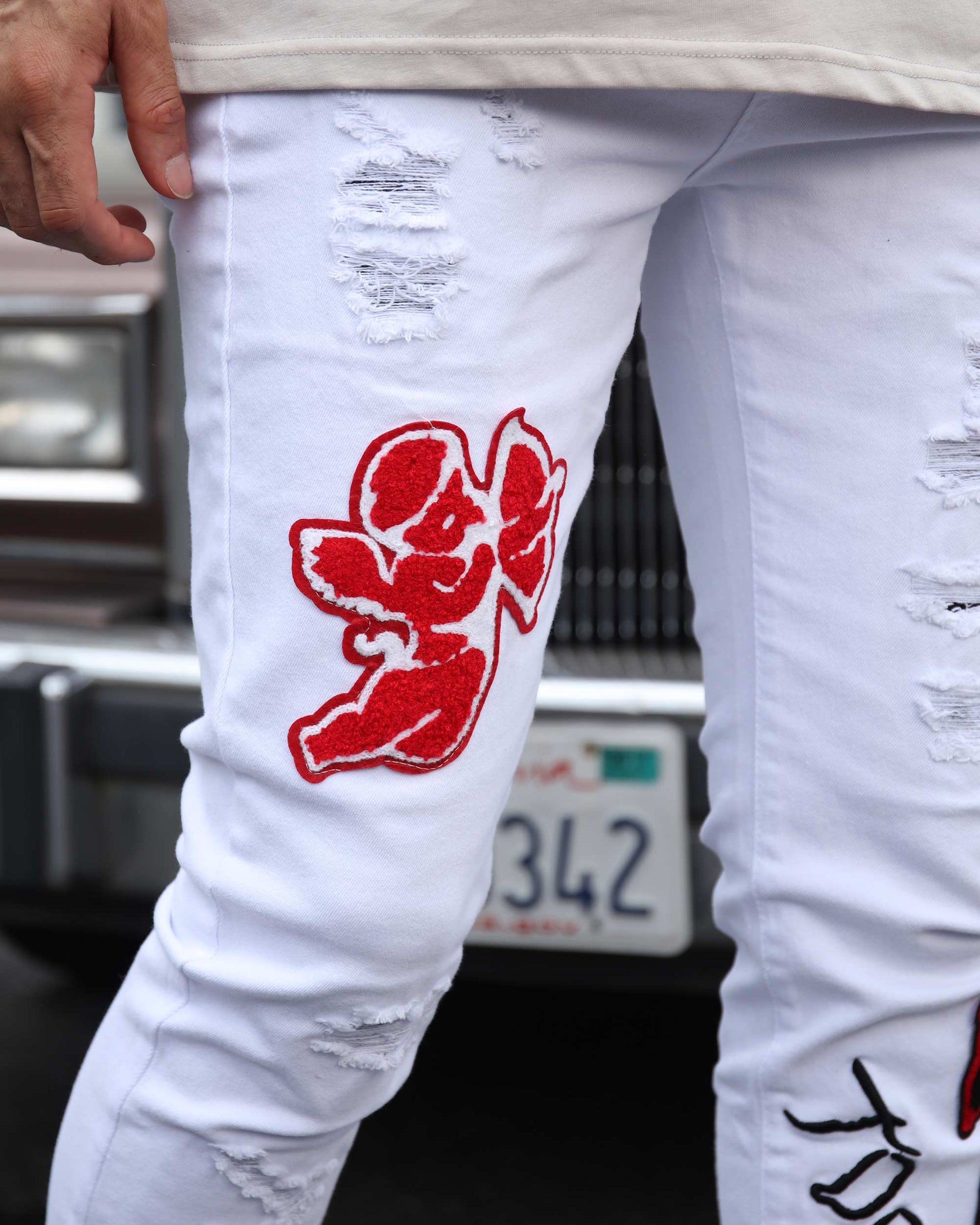 Logeqi graffiti embroidered jeans with red designs and distressed details for a stylish look