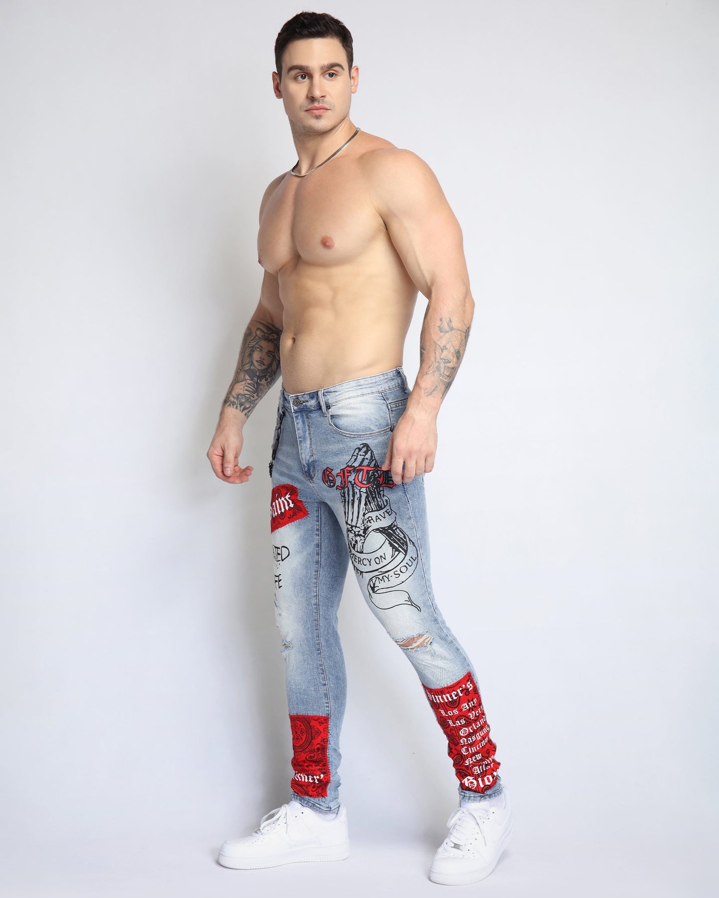 Logeqi graffiti ripped jeans in light wash with bold red and black designs for a stylish urban look