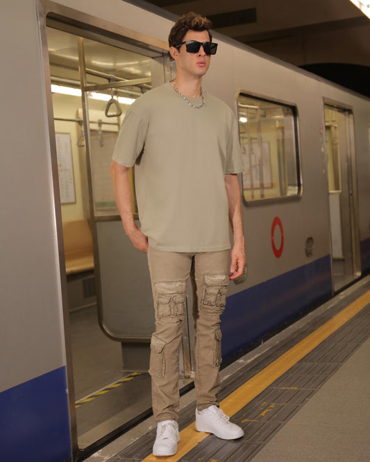Logeqi green crew neck t-shirt styled with cargo pants in an urban subway setting