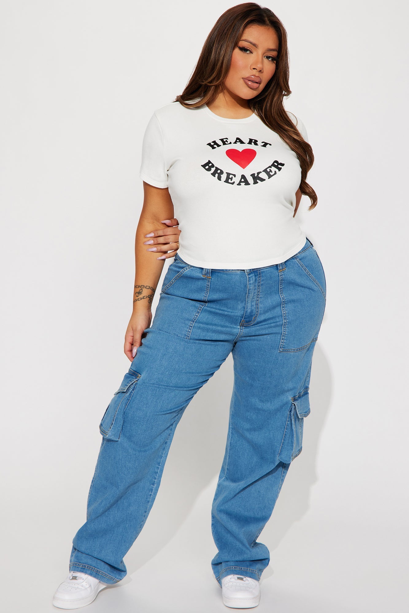Fashion Nova I Love Breaking Hearts tee styled with blue cargo pants for a trendy look