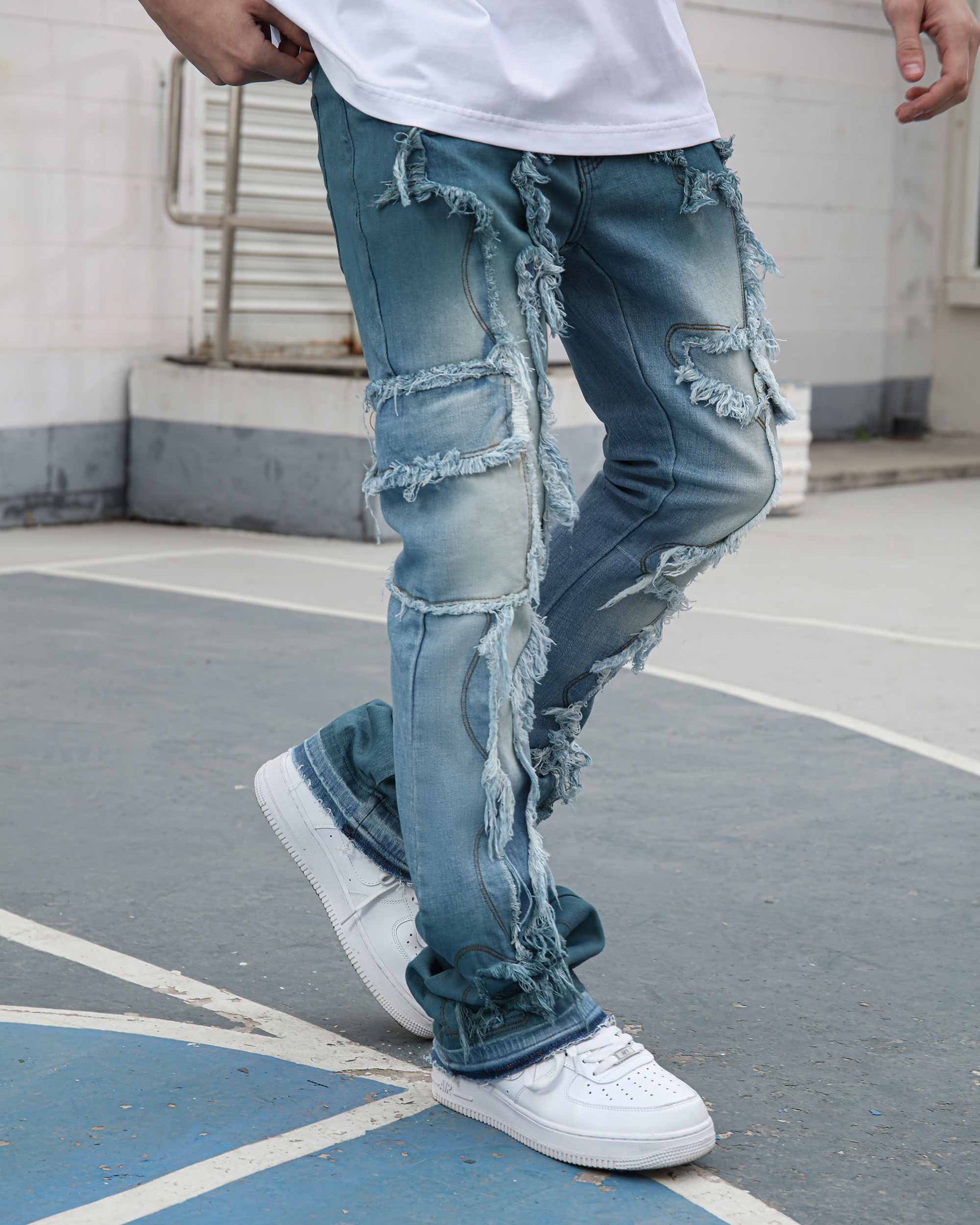 Logeqi irregular blue stacked jeans with ripped detailing and a trendy distressed look