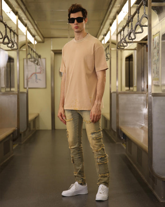 Trendsetting Logeqi khaki crew neck t-shirt styled with distressed jeans and white sneakers