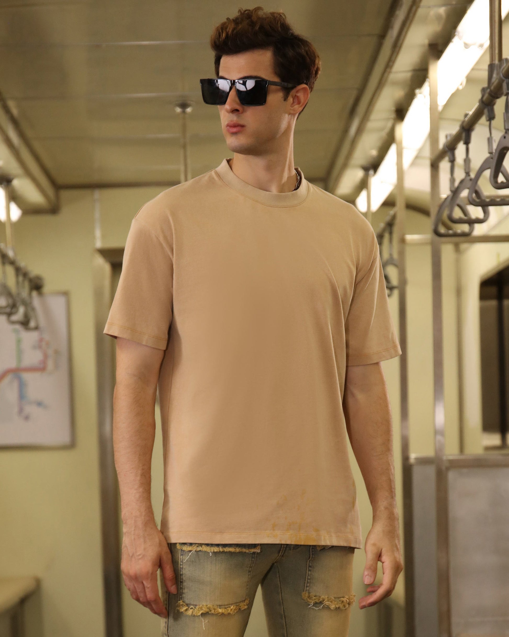 Logeqi khaki crew neck t-shirt worn by a model in a stylish urban setting