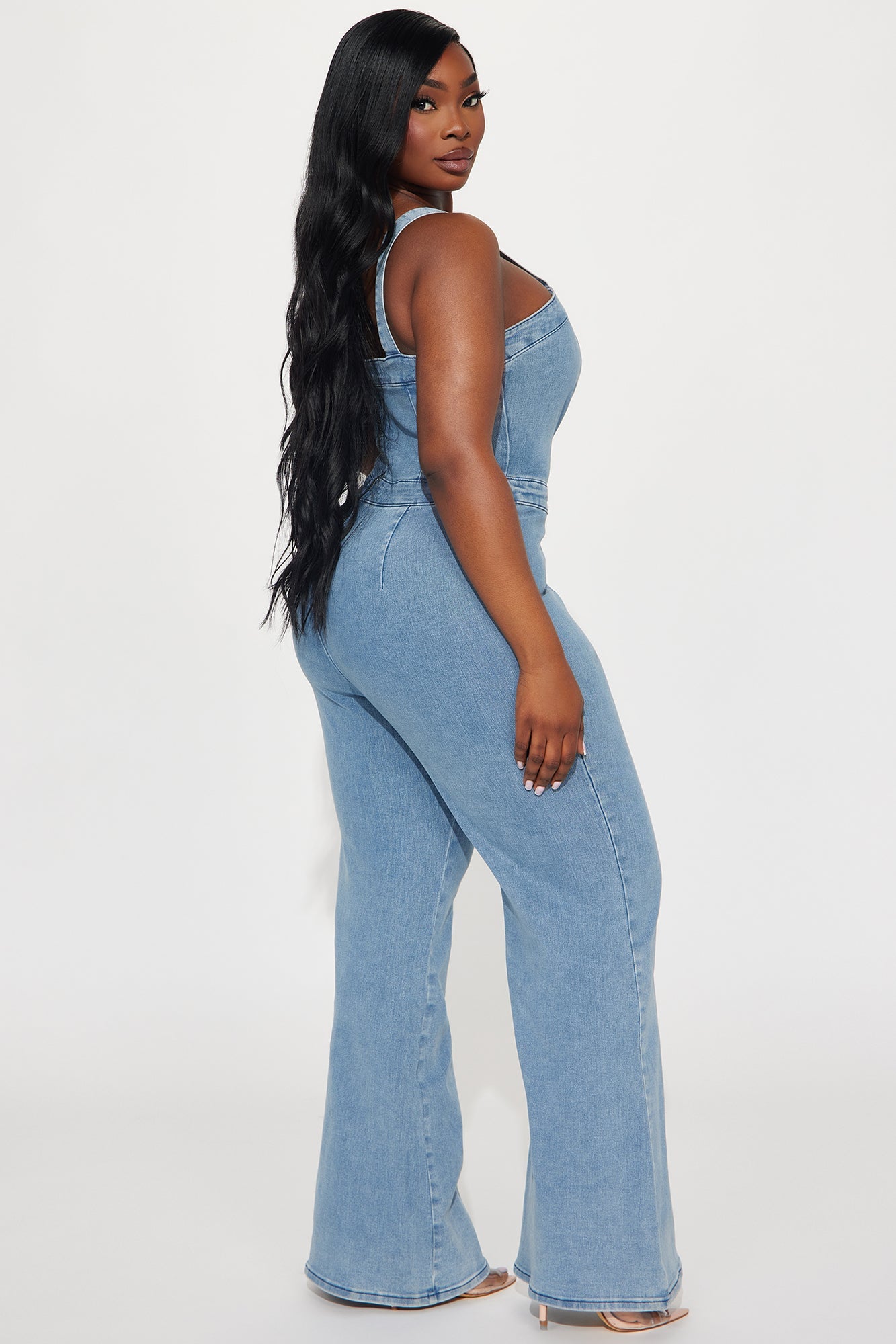 Fashion Nova light wash denim jumpsuit with a fitted design and flared legs for a trendy look