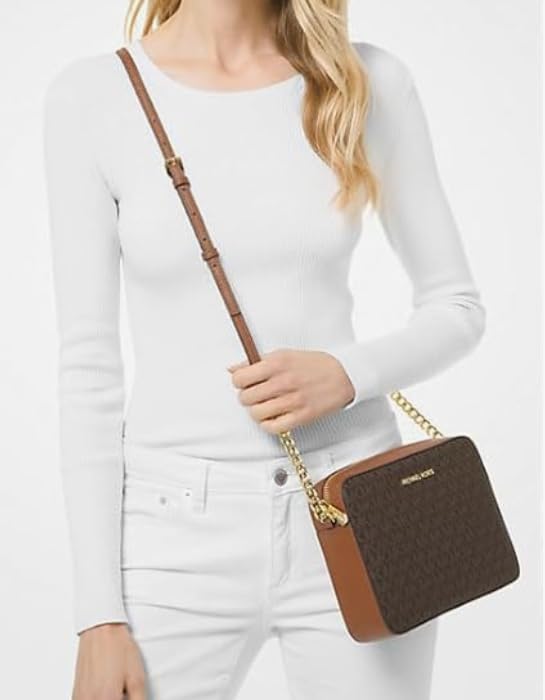 Stylish woman wearing a Michael Kors vanilla crossbody bag with a chic outfit for everyday use