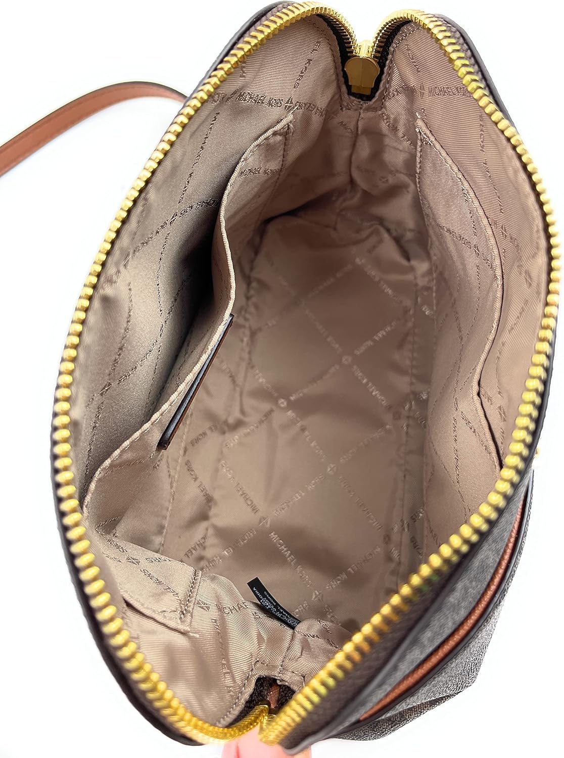 Inside view of Michael Kors crossbody leather handbag featuring spacious compartments and luxurious lining