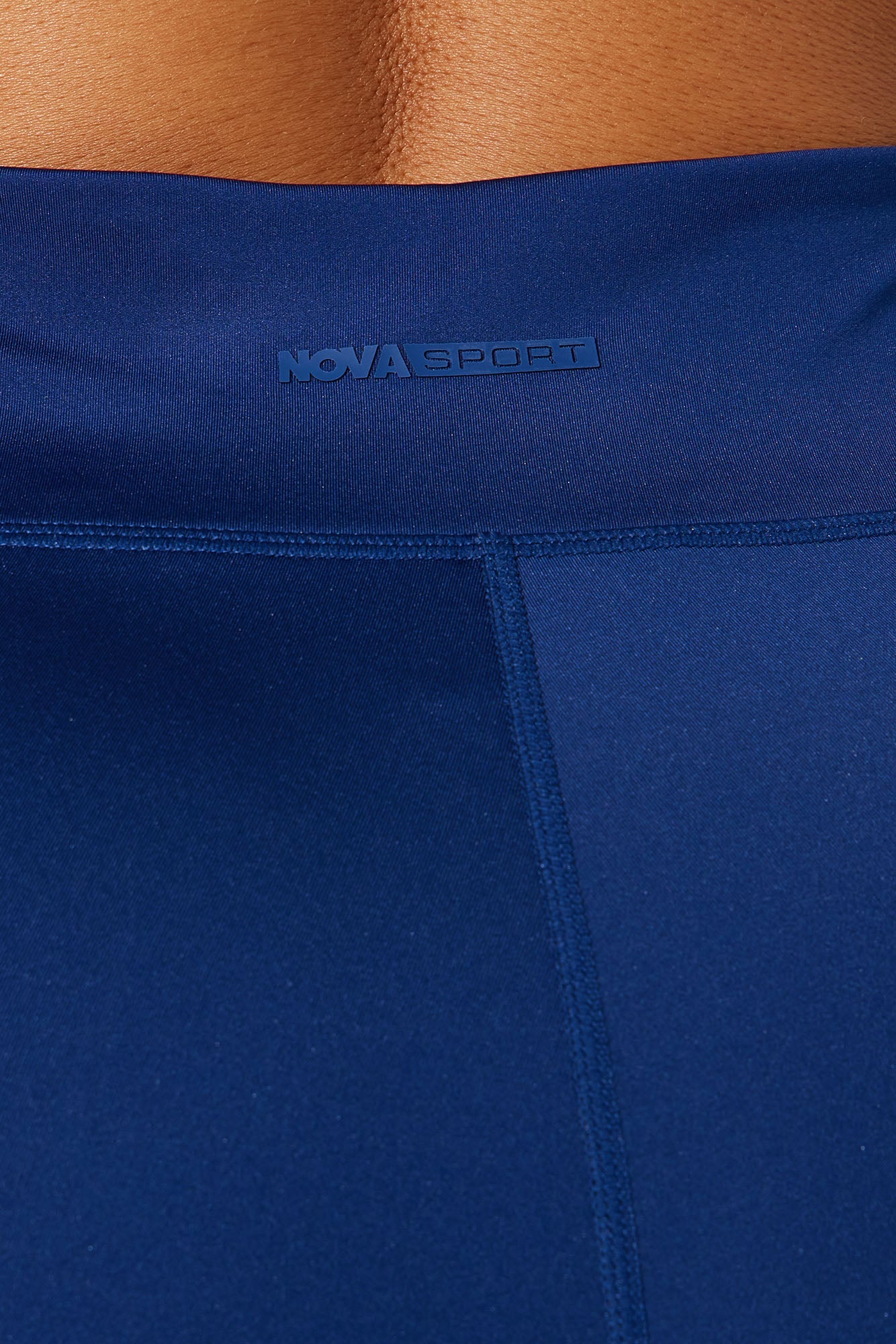 Close-up of Nova Sport midnight blue active leggings showcasing smooth fabric and logo detail