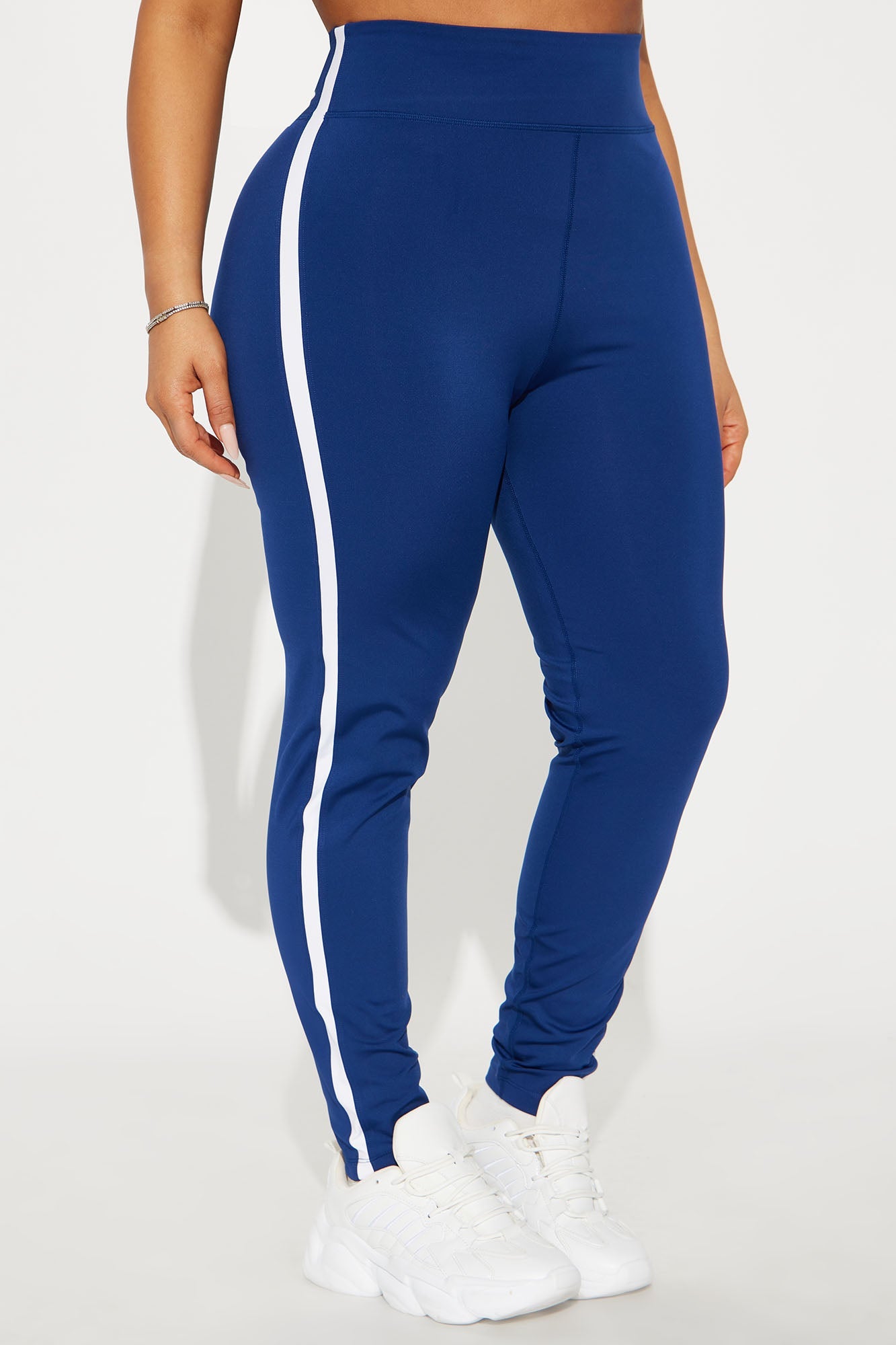 Fashion Nova midnight blue active leggings with white side stripes and a high waist design