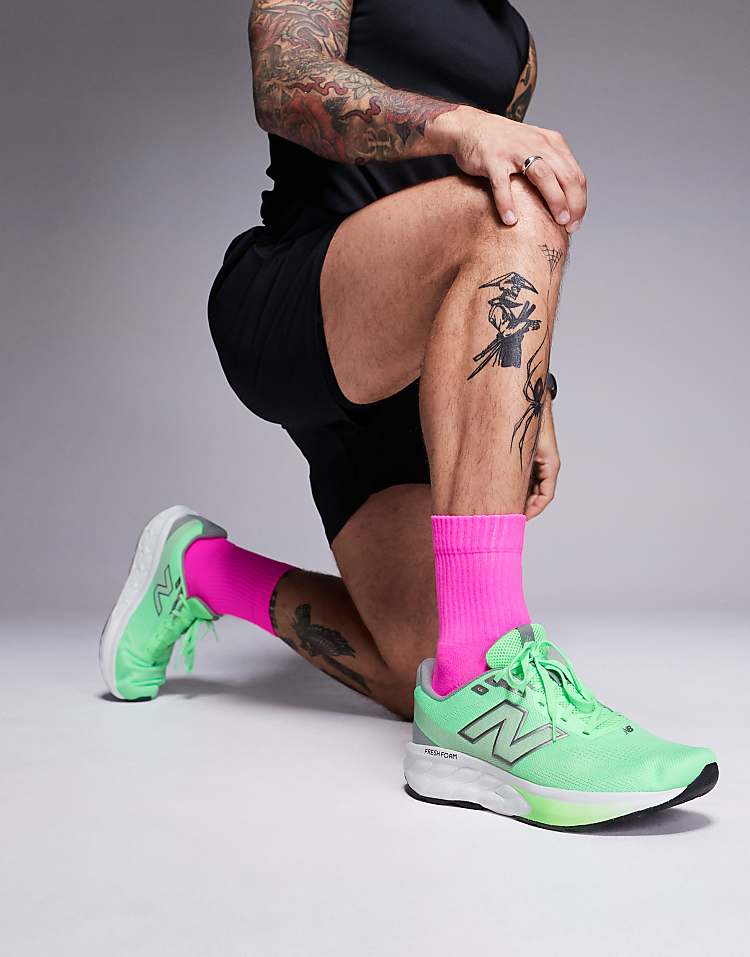 Modan Online New Balance 520 running shoes in green worn with bright pink socks on tattooed man