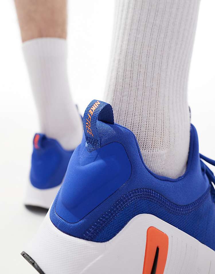 Close-up of Nike Free Metcon 6 white blue sneakers featuring a padded ankle collar and vibrant design