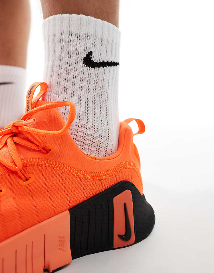 Close-up of Nike Free Metcon 6 white blue sneakers paired with athletic socks for a stylish workout look