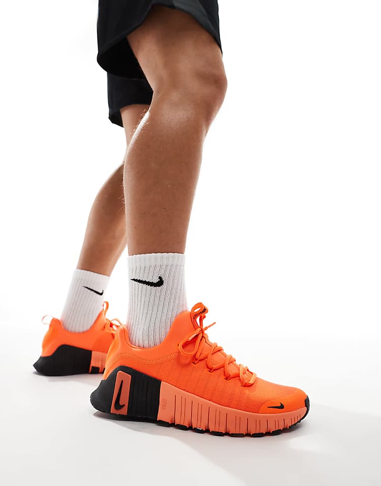 Nike Free Metcon 6 unisex sneakers in bright orange with flexible soles for training workouts