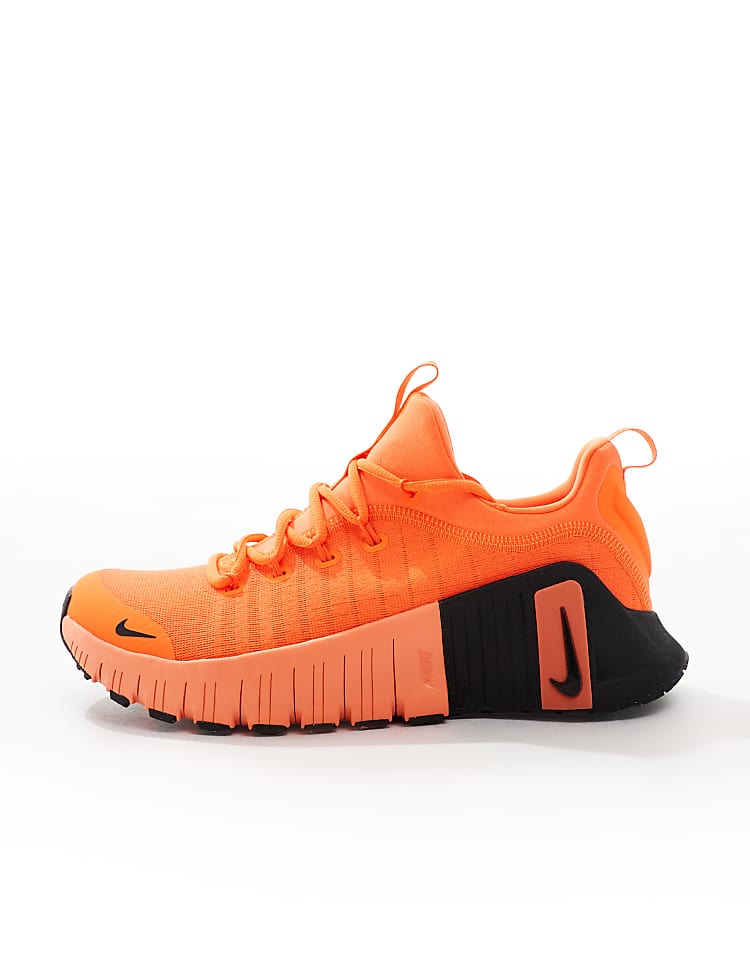 Nike Free Metcon 6 unisex sneakers in vibrant orange with black detailing for versatile training.