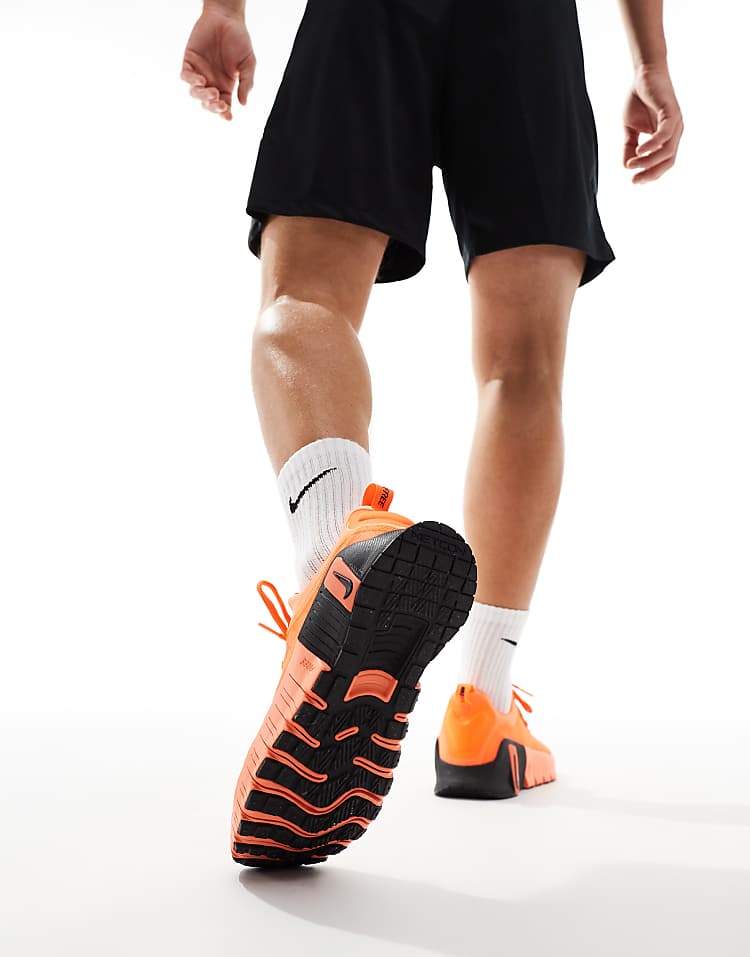 Nike Free Metcon 6 unisex sneakers in vibrant orange with a textured black outsole for enhanced grip
