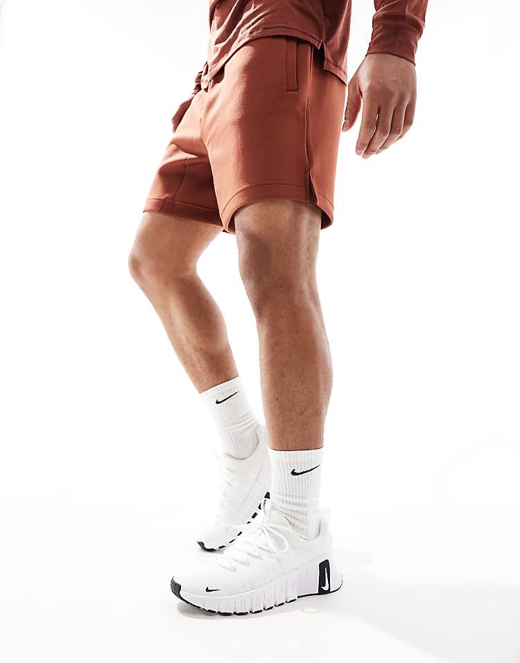 Nike Free Metcon 6 unisex sneakers worn with brown shorts and white socks for active lifestyle
