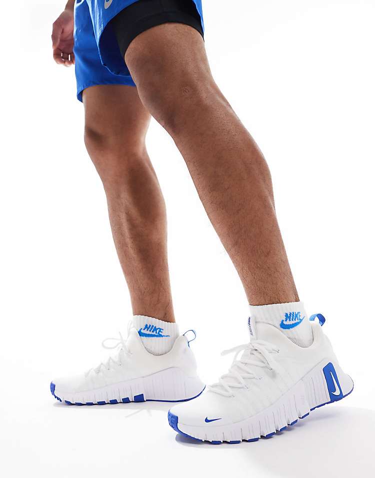 Nike Free Metcon 6 white blue sneakers shown on a person in athletic wear for training and workouts