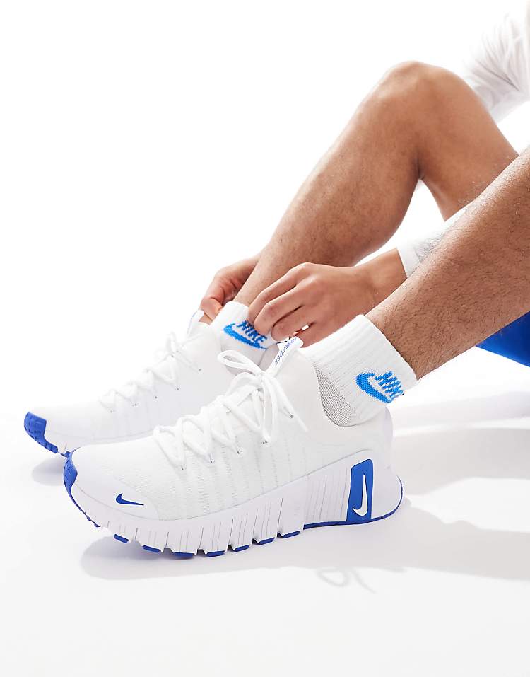 Nike Free Metcon 6 white blue sneakers worn by a model, showcasing comfort and style for workouts