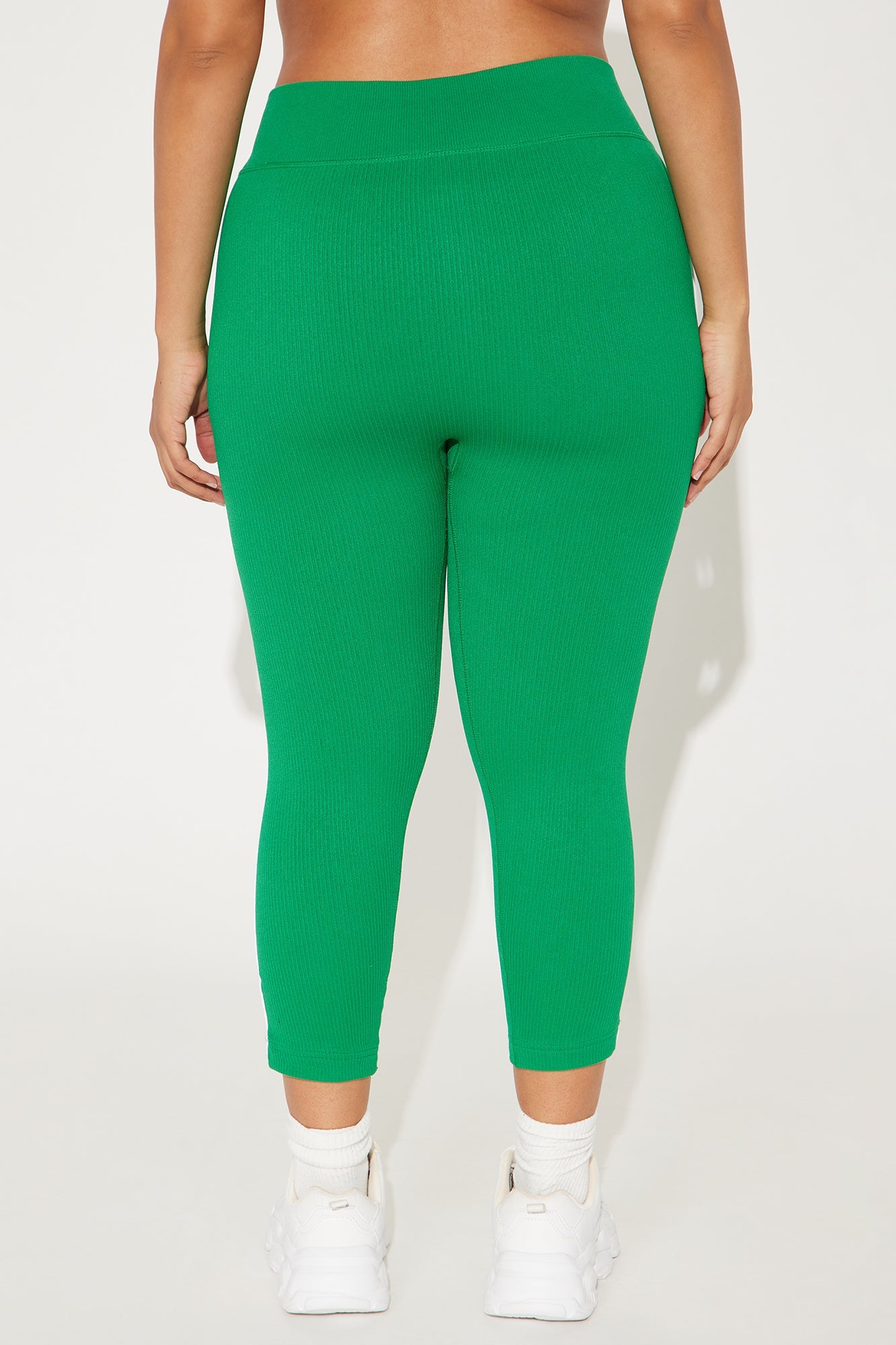 Back view of kelly green capri leggings from Fashion Nova, featuring a comfortable waistband and fitted design