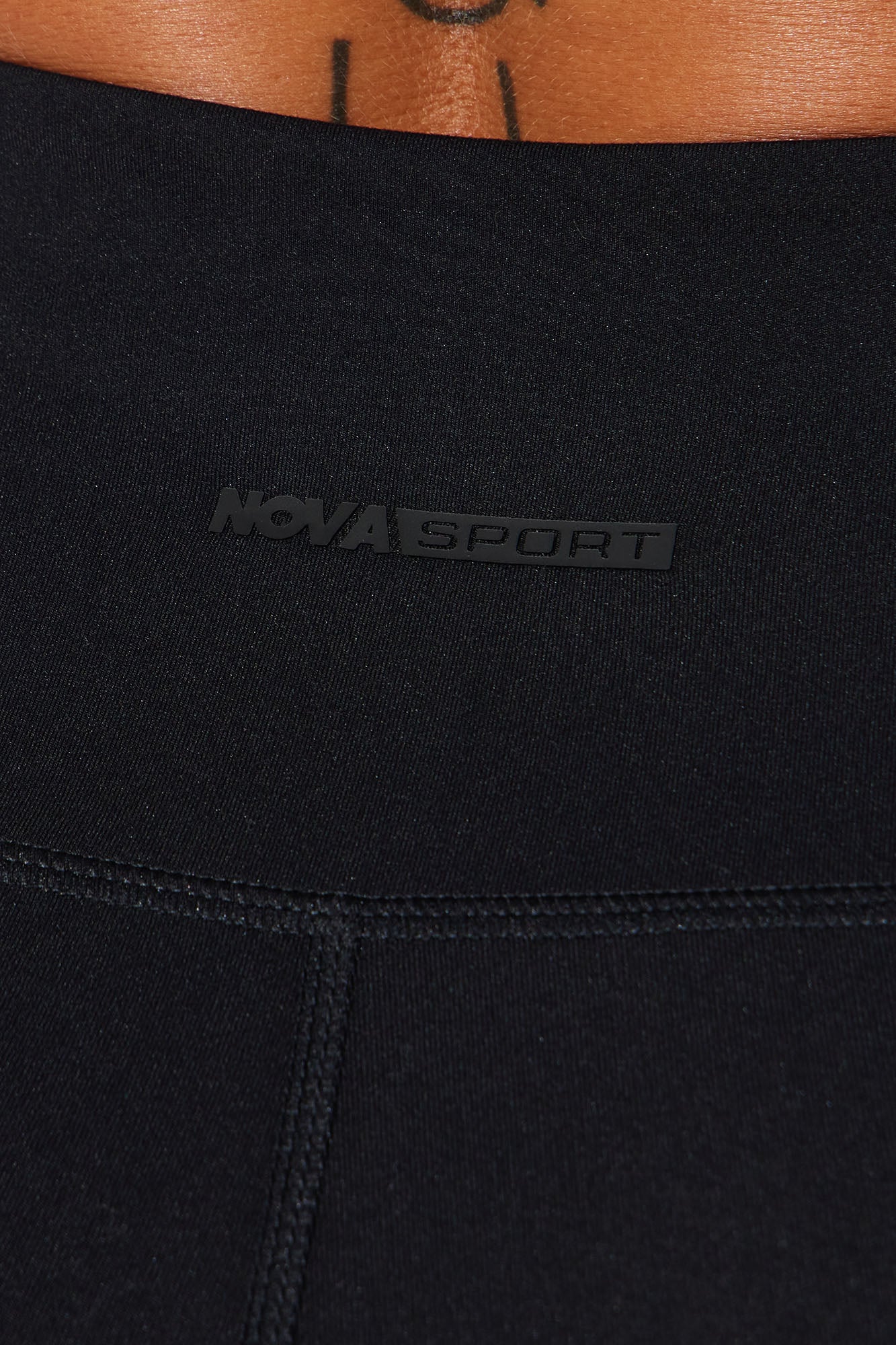 Close-up of Nova Sport logo on super soft capri leggings showcasing their comfortable fit