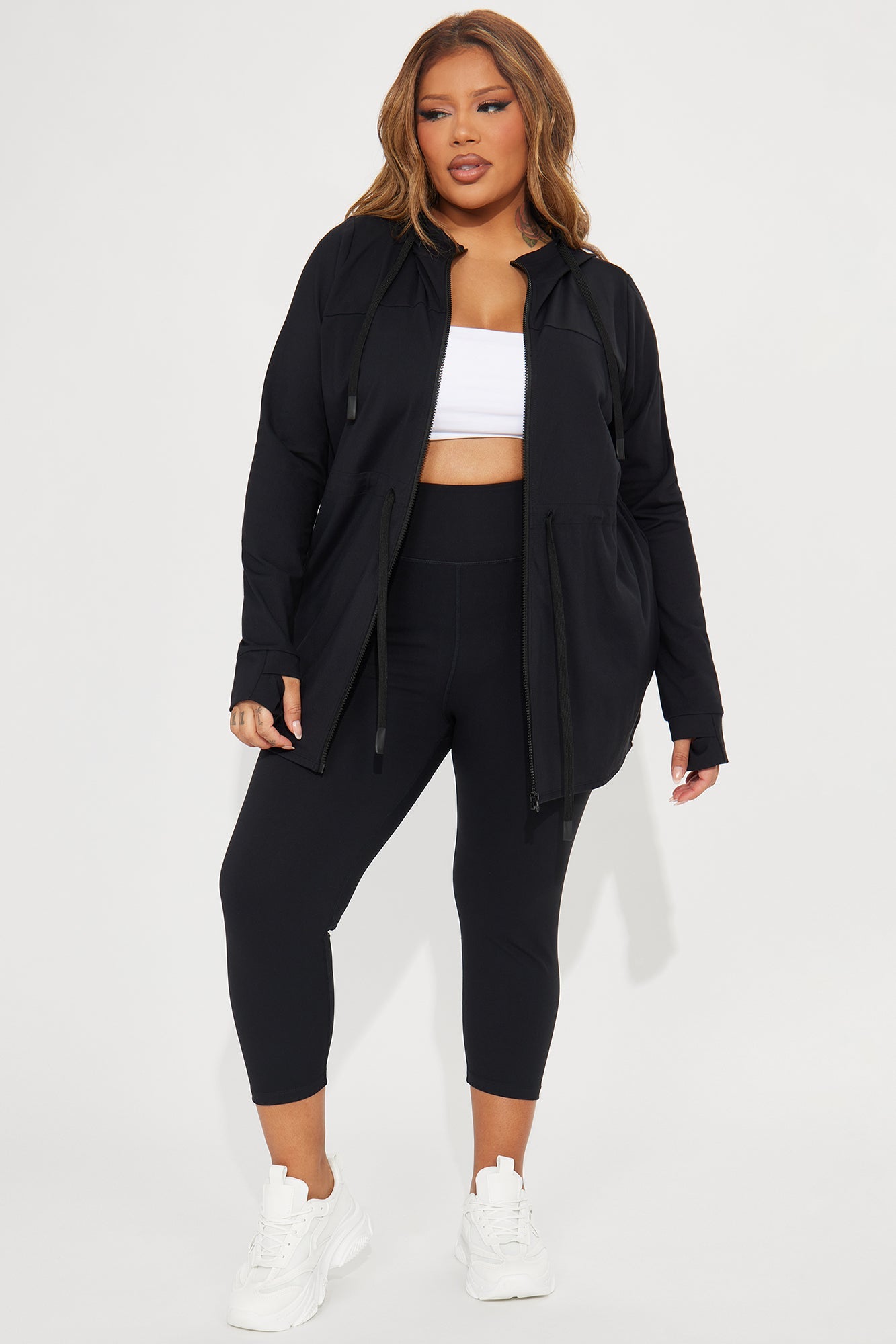 Fashion Nova model wearing super soft capri leggings paired with a cropped top and black jacket